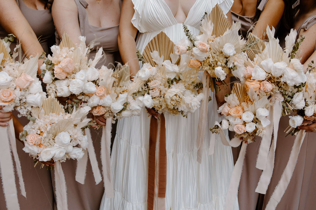 Brides and bridesmaids hold dried flower wedding bouquets from Hidden Botanic.
