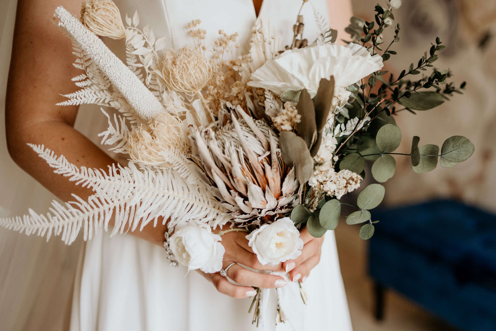 Bride holds a dried wedding bouquet from Hidden Botanics.